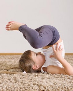 Cute little girl yoga exercising at home
